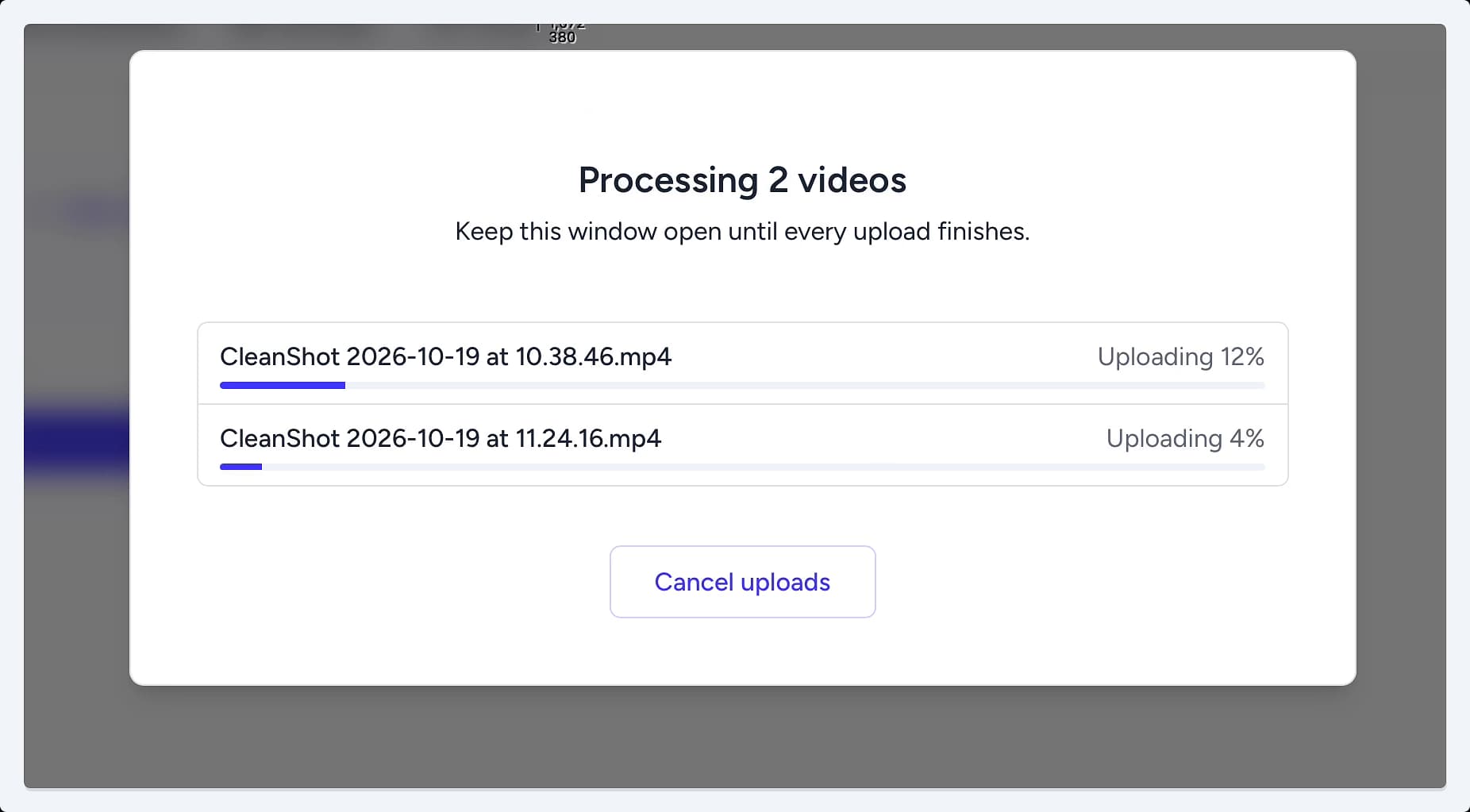 The Processing 2 videos modal displaying two video files with individual progress bars showing the upload percentage. The Processing 2 videos modal displaying two video files with individual progress bars showing the upload percentage.